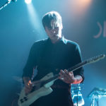 The lead singer from the band Jimmy Eat World plays his guitar on stage at the Algonquin Commons Theatre