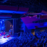 A view of the Tea Party playing on stage at the Algonquin Commons Theatre. You can see the floor, main, and balcony levels full of the audience